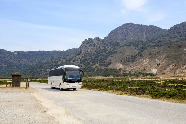 Nisyros, Greece - May 10, 2023: A tour bus heading to the Stefanos crater on Nisyros island. Greece