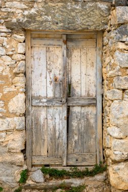 Old Greek wooden door in Tholaria village on Amorgos island, Greece clipart