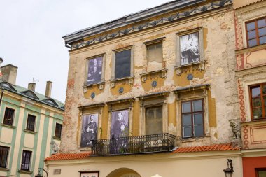 Lublin, Poland - September 12, 2022: Burgher tenement house with photos of former residents in the Old Town of Lublin clipart