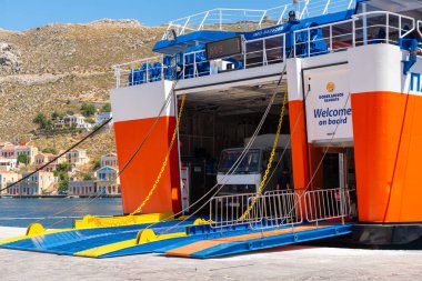 Symi, Greece - May 15, 2018: Dodekanisos Seaways ferry in the port of Symi Island. Dodecanese, Greece clipart