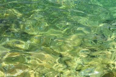 Surface of the sea. Natural texture of sea water. Emerald ocean water background