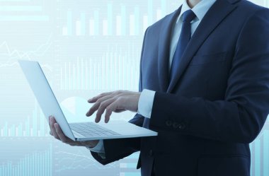 Business sperson, iş finansmanı analizi için dizüstü bilgisayar kullanıyor. Arkaplan ve grafikler