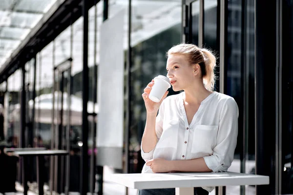 Beautiful Woman Drinking Coffee Near Office Building. Portrait Of Successful Business Woman Holding Cup Of Hot Drink In Hand Outside. High Resolution.