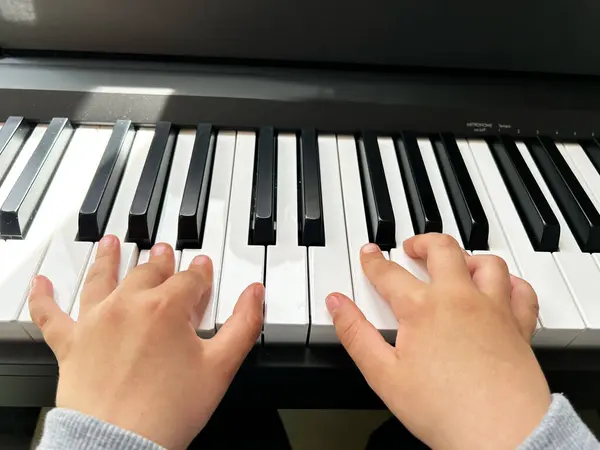 Elektronik piyanoda çocuk elleri
