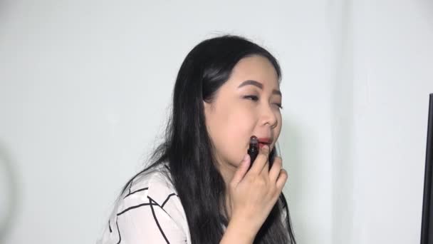 Adult Asian Female Applying Lipstick Isolated — Stock Video