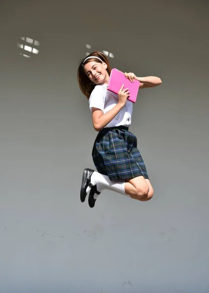 A Happy Excited Girl Student Jumping