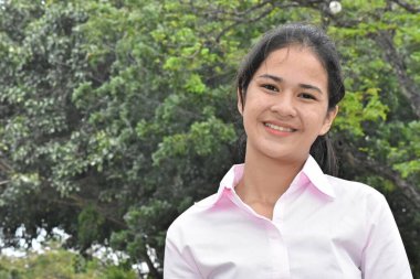 A Smiling Beautiful Asian Girl Outside