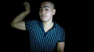 A Strong Asian Man Flexing Muscles