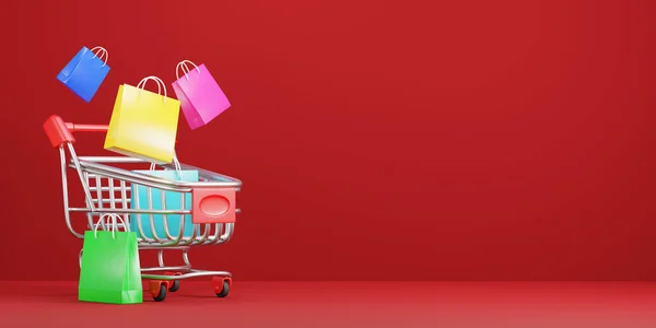 Kırmızı Arka Planda Renkli Alışveriş Çantalı Alışveriş Arabası — Stok fotoğraf