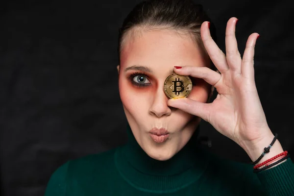 stock image Beautiful woman holding a bitcoin, in different facial expressions, studio shot