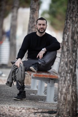 Doğal görünüşlü, açık havada poz veren, günlük kıyafetler giyen, montaj yapmayan biri.