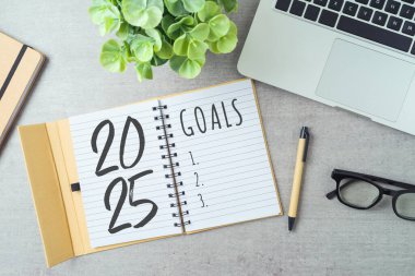 New Year 2025 goals and resolution business concept with notebook, laptop computer and plant on modern office desk. Top view, flat lay clipart