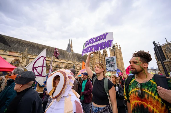 stock image LONDON - April 22, 2023: Experience the collective strength as protesters march past the Houses of Parliament during the XR demonstration, demanding action for a sustainable future.