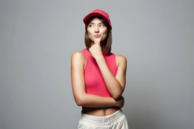 Funny beautiful Girl in Red Hat. Smiling young woman portrait