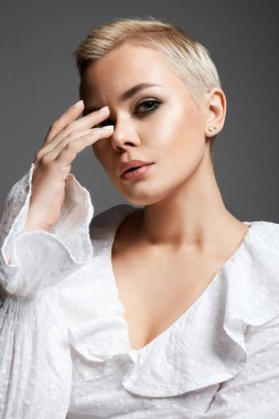 portrait of Short Hair Beautiful young woman. sensual girl with make-up and blond Hair. Bald style