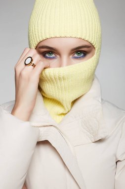 personl in yellow balaclava. Trendy Mask on pretty woman. winter fashion