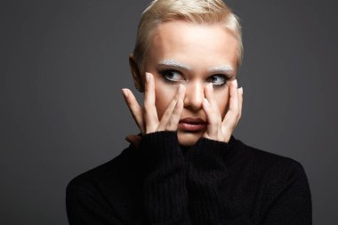 portrait of Short Hair Beautiful young woman with white snow brows. sensual blond girl with fancy makeup. Bald style