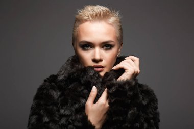 young short blond hair woman in fur. beautiful girl. Winter fashion