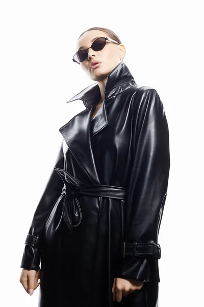 stock image fashion portrait of Beautiful woman in sunglasses and leather trench coat. beauty girl in trendy Glasses