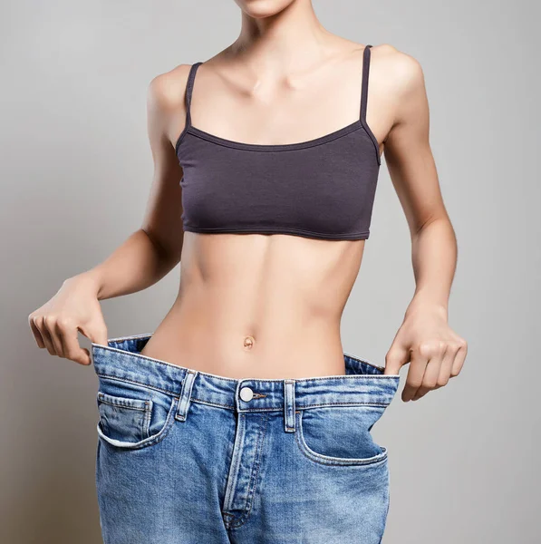slimming Young woman in jeans. low waist. Beautiful Thin body Girl