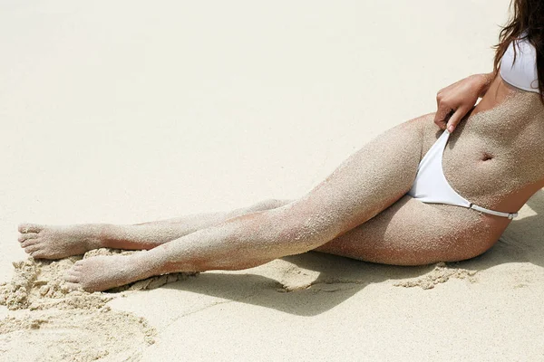 Beautiful body woman in sand on the beach. Sexy girl in Bikini. long female legs. vacation