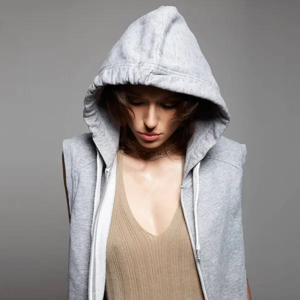 young woman in hood. person with head covered. sexy girl in hoodie