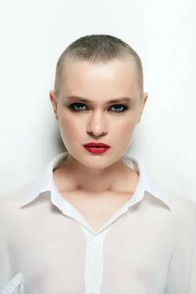 pretty woman with short haircut. portrait of bald girl with red lipstick