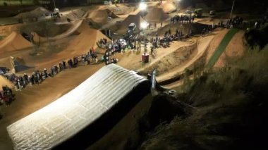 Night aerial shot of night ride at Lapoma bike park during - Happy Ride Weekend event, Catalonia Spain, 19 dec 2022. High quality 4k footage