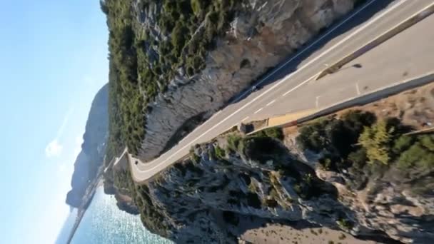 Dynamic Fpv Drone Shot Motorcycle Driving Cliff Serpentine Road Sea — Video