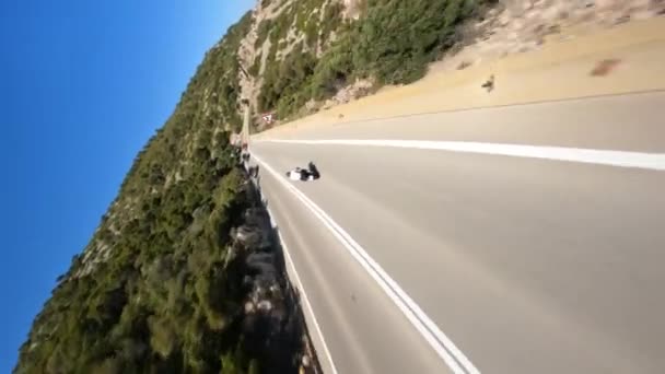 Dynamic Fpv Drone Shot Motorcycle Driving Cliff Serpentine Road Sea — Wideo stockowe