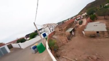 FPV drone shot Flight above little white town San lucar de Guadiana in Spain and crossing the river to the Portugal side. High quality 4k footage