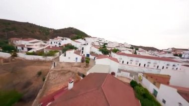 FPV drone shot Flight above little white town San lucar de Guadiana in Spain and crossing the river to the Portugal side. High quality 4k footage