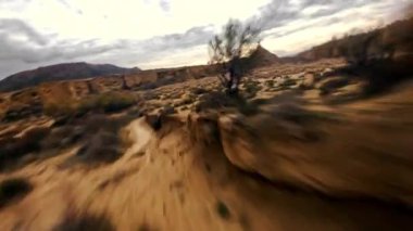 Dynamic Fpv drone shot of Bardenas Reales desert at high speed flying between narrow gorges and canyons, Mars landscape, another planet. Beautiful desert landscape in southeast Navarre, Spain. High