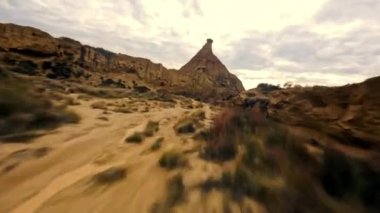 Dynamic Fpv drone shot of Bardenas Reales desert at high speed flying between narrow gorges and canyons, Mars landscape, another planet. Beautiful desert landscape in southeast Navarre, Spain. High