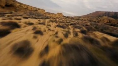 Dynamic Fpv drone shot of Bardenas Reales desert at high speed flying between narrow gorges and canyons, Mars landscape, another planet. Beautiful desert landscape in southeast Navarre, Spain. High