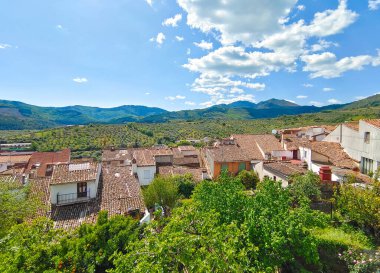 Caceres eyaletindeki Guadalupe 'deki evler bulutlu bir günde dağlarla çevrili.
