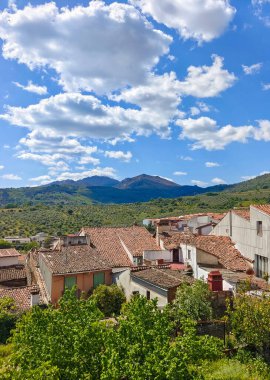 Caceres eyaletindeki Guadalupe 'deki evler bulutlu bir günde dağlarla çevrili.