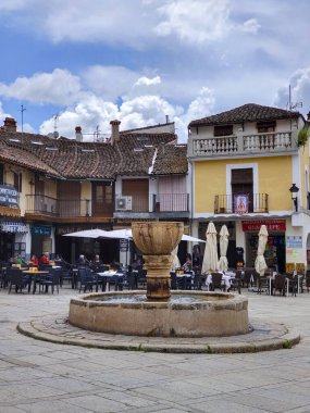 Guadalupe, Spain-May, 2022. Tourist in the square of abbey in a restaurant and walking in a sunny day.