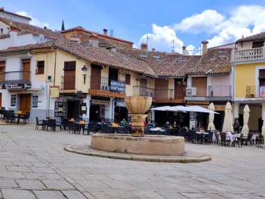 Guadalupe, Spain-May, 2022. Tourist in the square of abbey in a restaurant and walking in a sunny day.