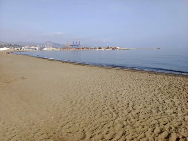 Sand beach in Malaga province in a cloudy day clipart