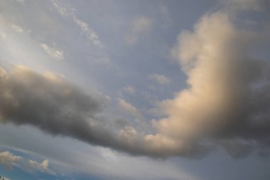 Shaped like an arrow-head a cloud moves through the afternoon sky