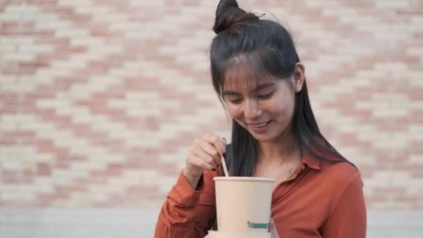 Young Asian Woman Looking Camera Smiling While Eating Food Reusable — Stock Video