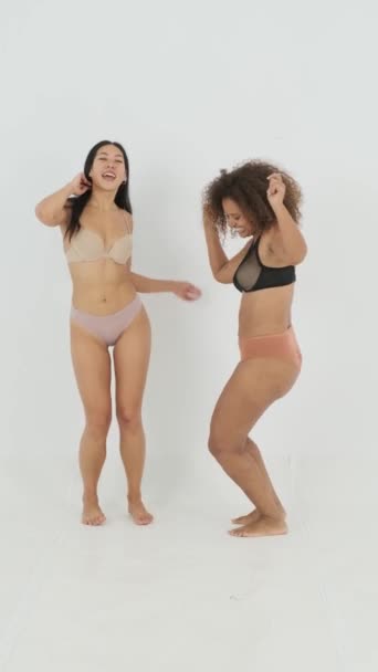 Static Shot Cheerful Diverse Girlfriends Underwear Raising Arms Swinging Hips — Stock Video