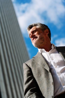 Finansal bölgede yetişkin bir iş adamının düşük açılı dikey portresi