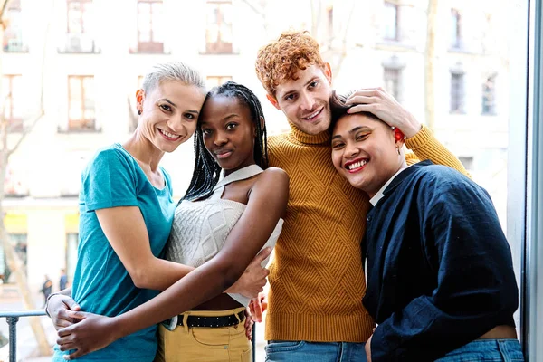 stock image Portrait of a multiethnic gay and lesbian couple embracing together on a balcony