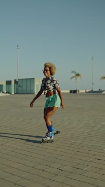 Vertical Slow Motion Video Happy African Woman Skating Inline Skates — Stock Video