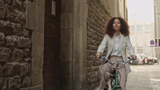 身着休闲装 骑着自行车穿过巴塞罗那哥特式街区的拉丁女孩 — 图库视频影像