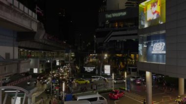 Bangkok 'taki hareketli kavşak yayalar ve araçlar hareketli şehir manzarasında gezinirken hareketli bir hareketle canlanıyor