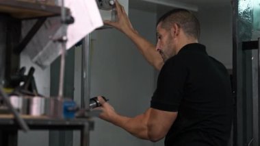 Makinist fabrika içinde endüstriyel ekipman işletiyor, üretim ortamında kalifiye işçilik sergiliyor.
