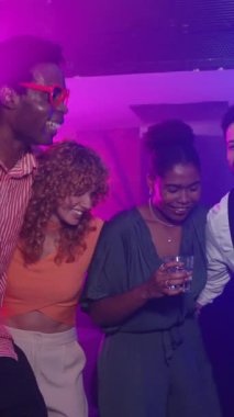 Genç yetişkinler bir gece kulübünde birlikte gülüp dans ediyorlar. Canlı ve ağır çekimde içki ve müzikten zevk alıyorlar.